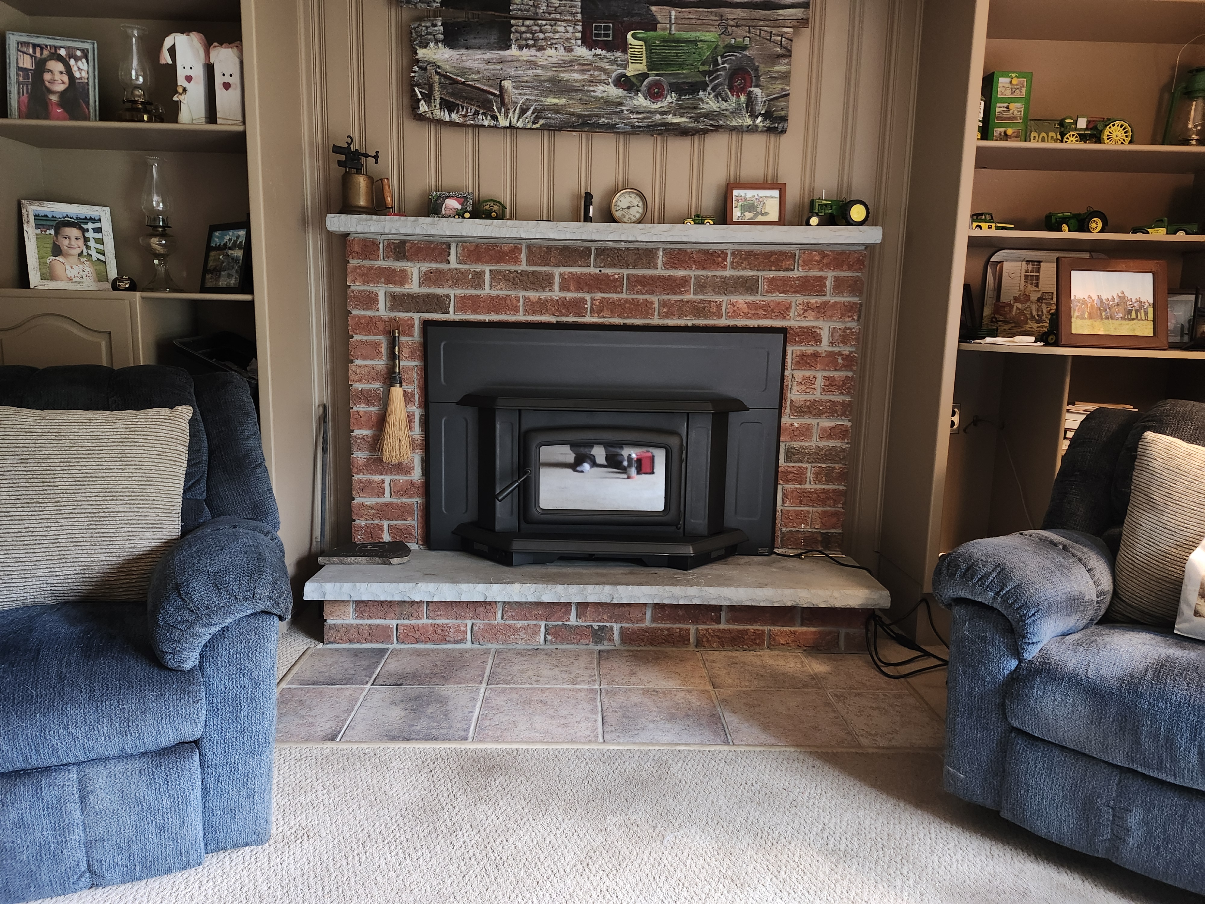 Maintaining a comfortable home starts with monitoring your heating systems and safety controls. A hand adjusting a smart thermostat in a cozy living room with soft afternoon light.