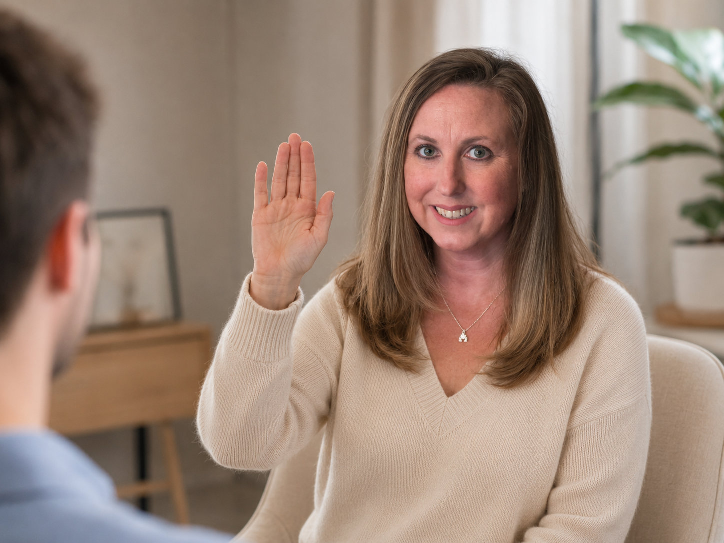 Virtual somatic therapy allows you to build a sense of safety within your own home environment. A therapist conducting a virtual somatic session through a laptop in a calm, professional home office.
