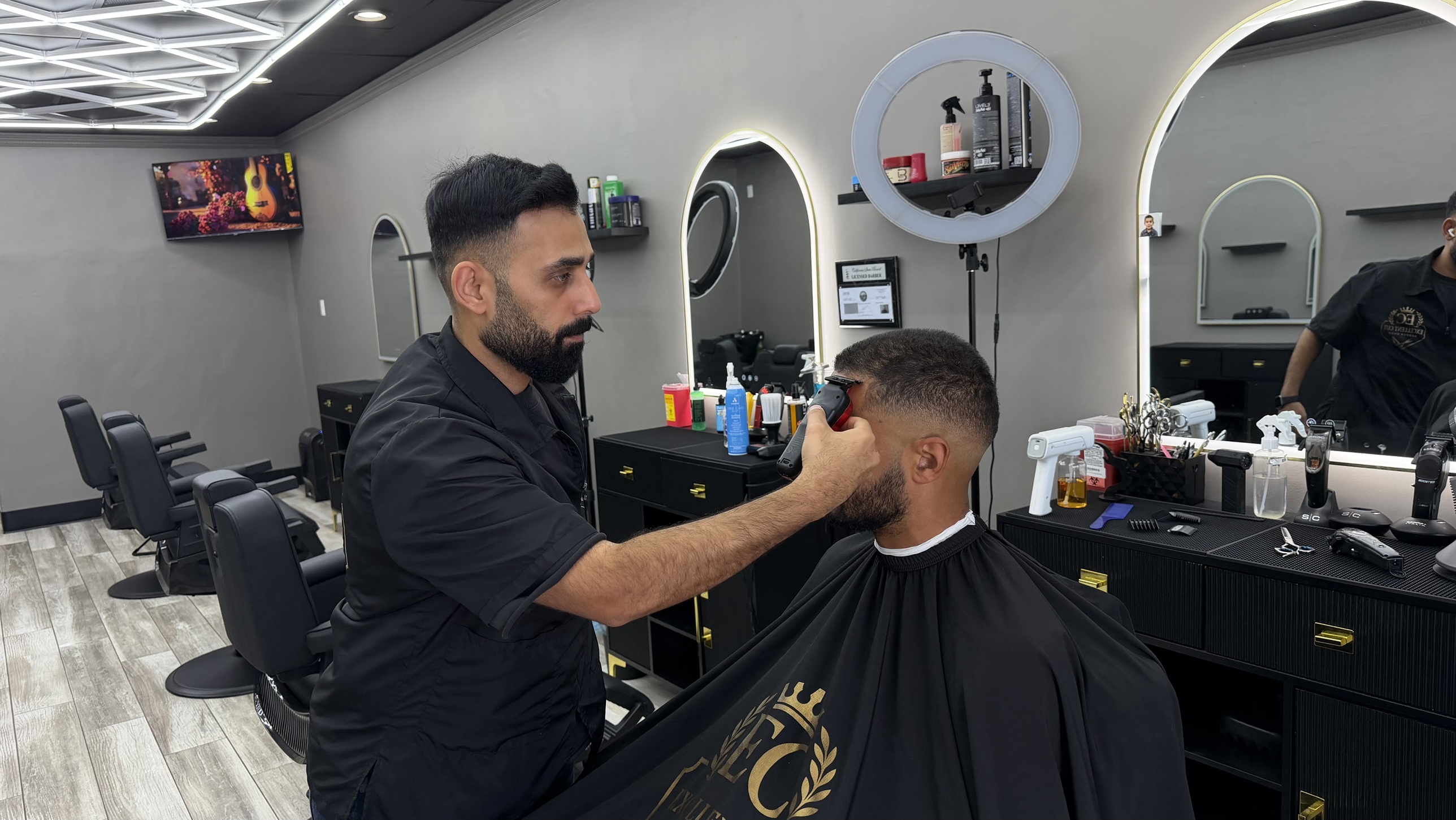 Precision starts with the right tools: professional grade equipment at Excellent Cut Barbershop. Professional barber tools including a straight razor and scissors resting on a leather chair armrest
