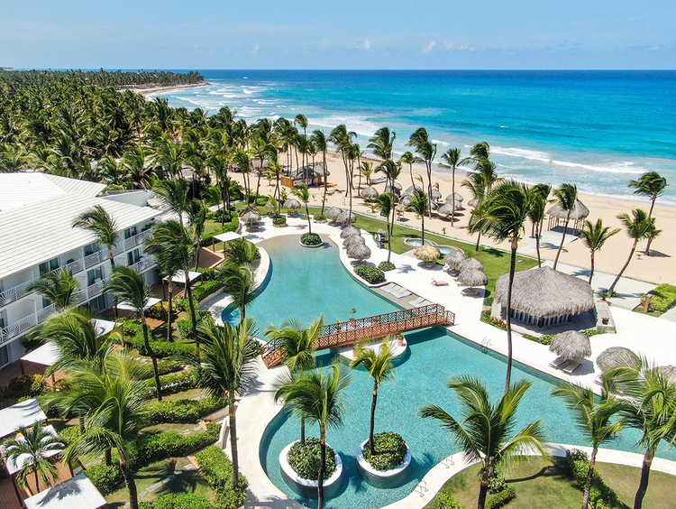 Escape the crowds at Uvero Alto's more secluded beach stretches. A relaxing beach setup with loungers and umbrellas on a pristine white sand beach in the Dominican Republic.