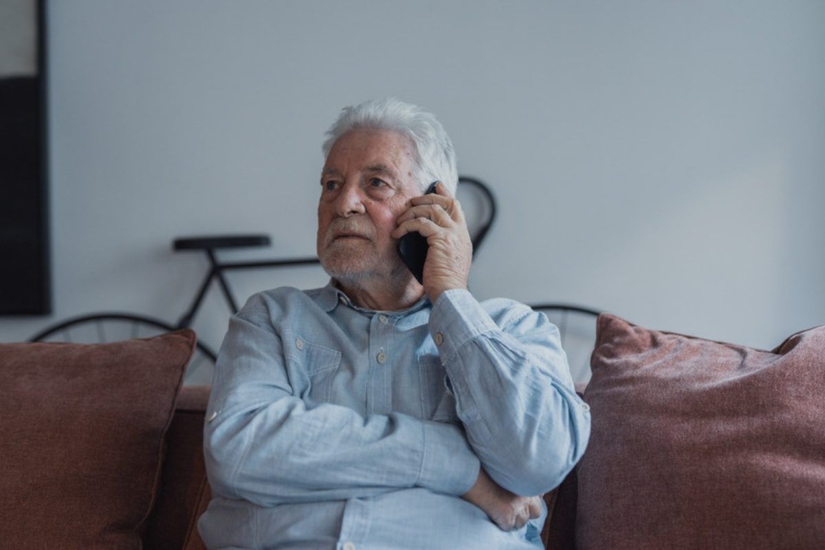 AI scam myths: concerned older man on a phone call at home