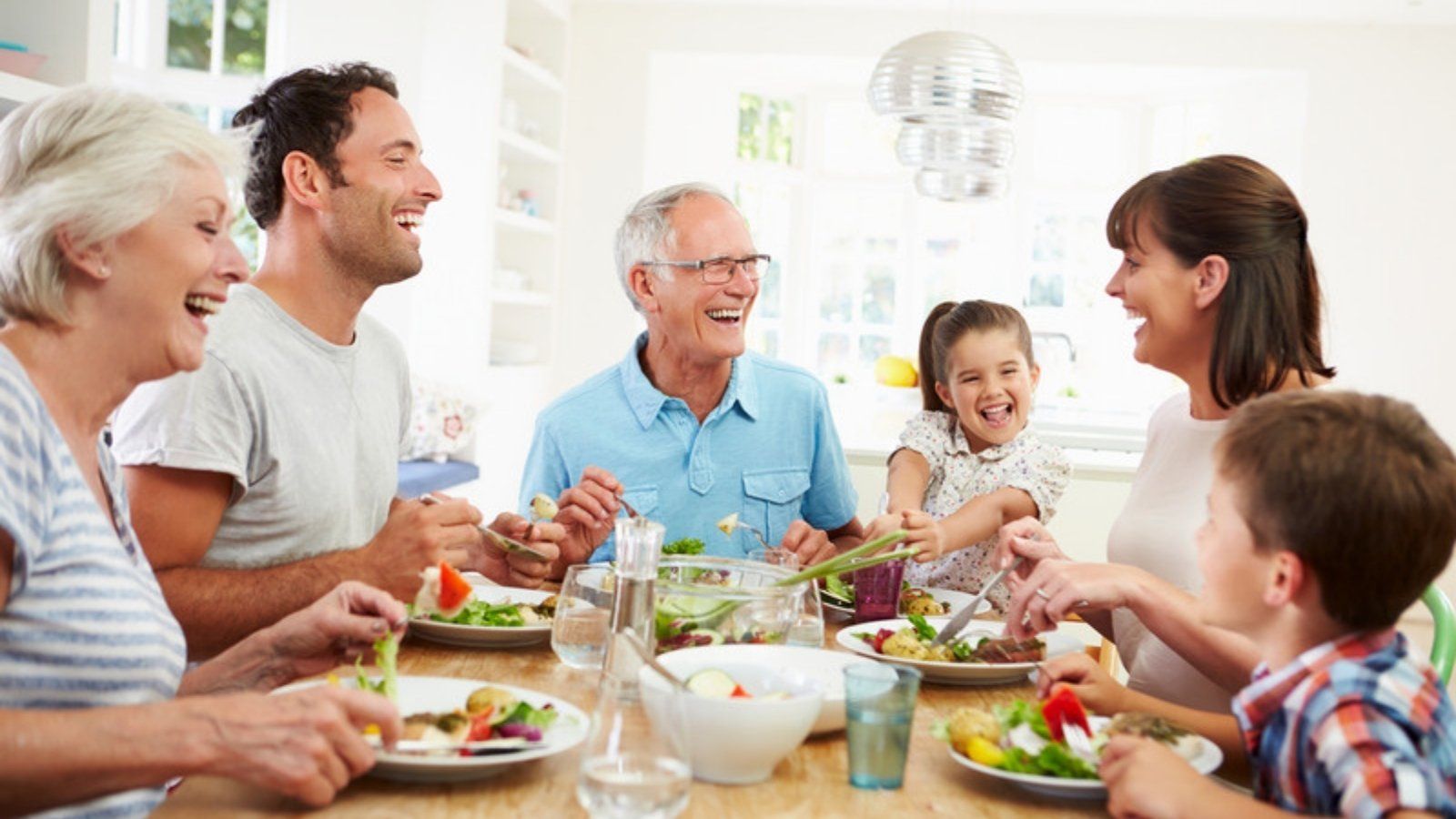 Three generations of a family at the table agreeing a family safe word to beat AI voice clone scams