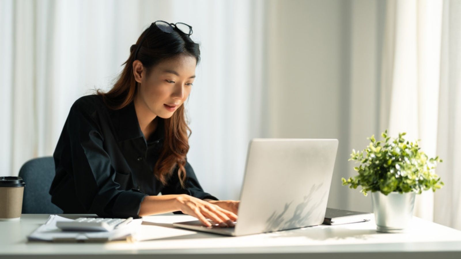 Woman reading online safety advice on her laptop, Practical Ways I Safeguard My Digital Life
