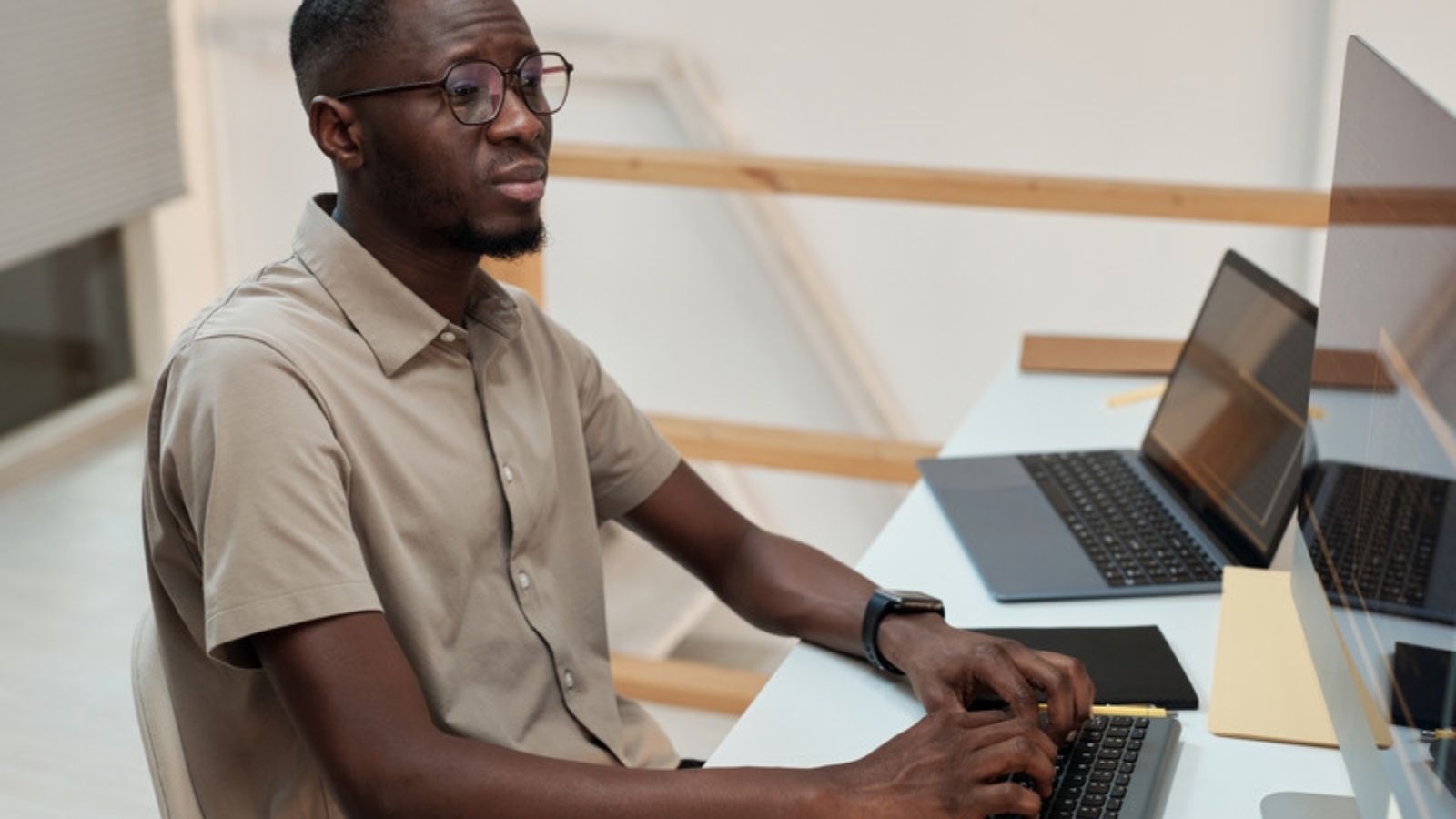 Man working at a desk with online safety in mind, Fixing Digital Security From Scratch, in Order