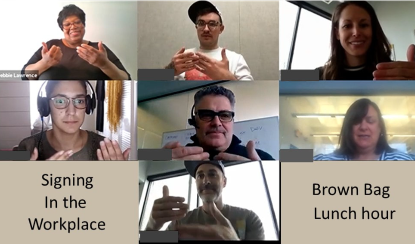 Customized training ensures your staff has the specific vocabulary they need for their unique industry. A professional woman sharing printed ASL resources with a group of adults in a community center setting.