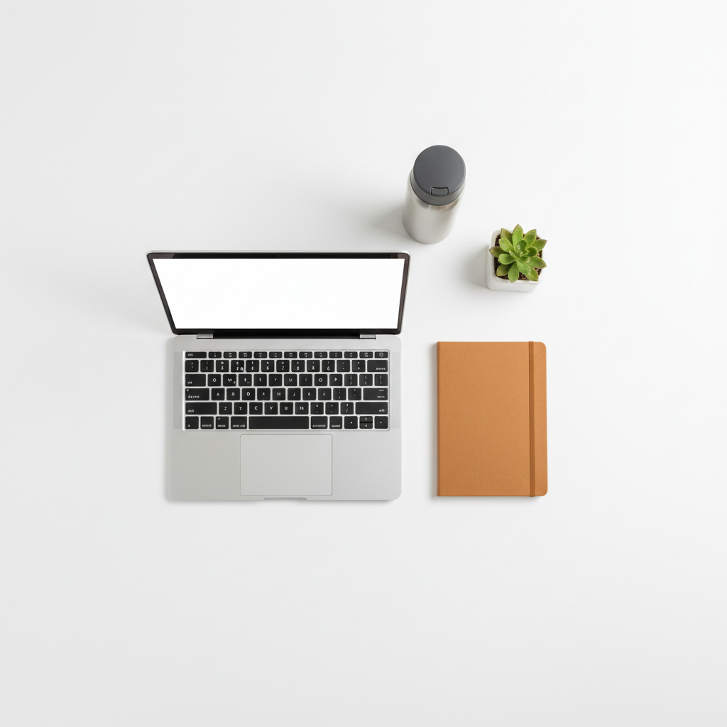 Gaining clarity on your numbers is the first step toward navigating your way out of debt. A clean, organized minimalist desk with a laptop and notebook, suggesting a fresh start and clear direction.