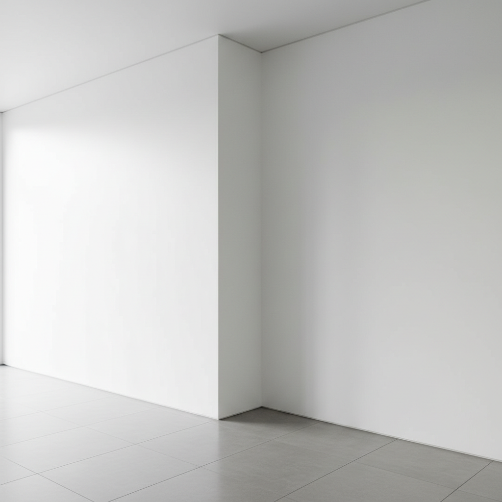 The professional difference: achieving sharp, crisp corners and a blemish-free finish. A perfectly finished white plastered wall corner showing a crisp smooth surface and bright interior light.