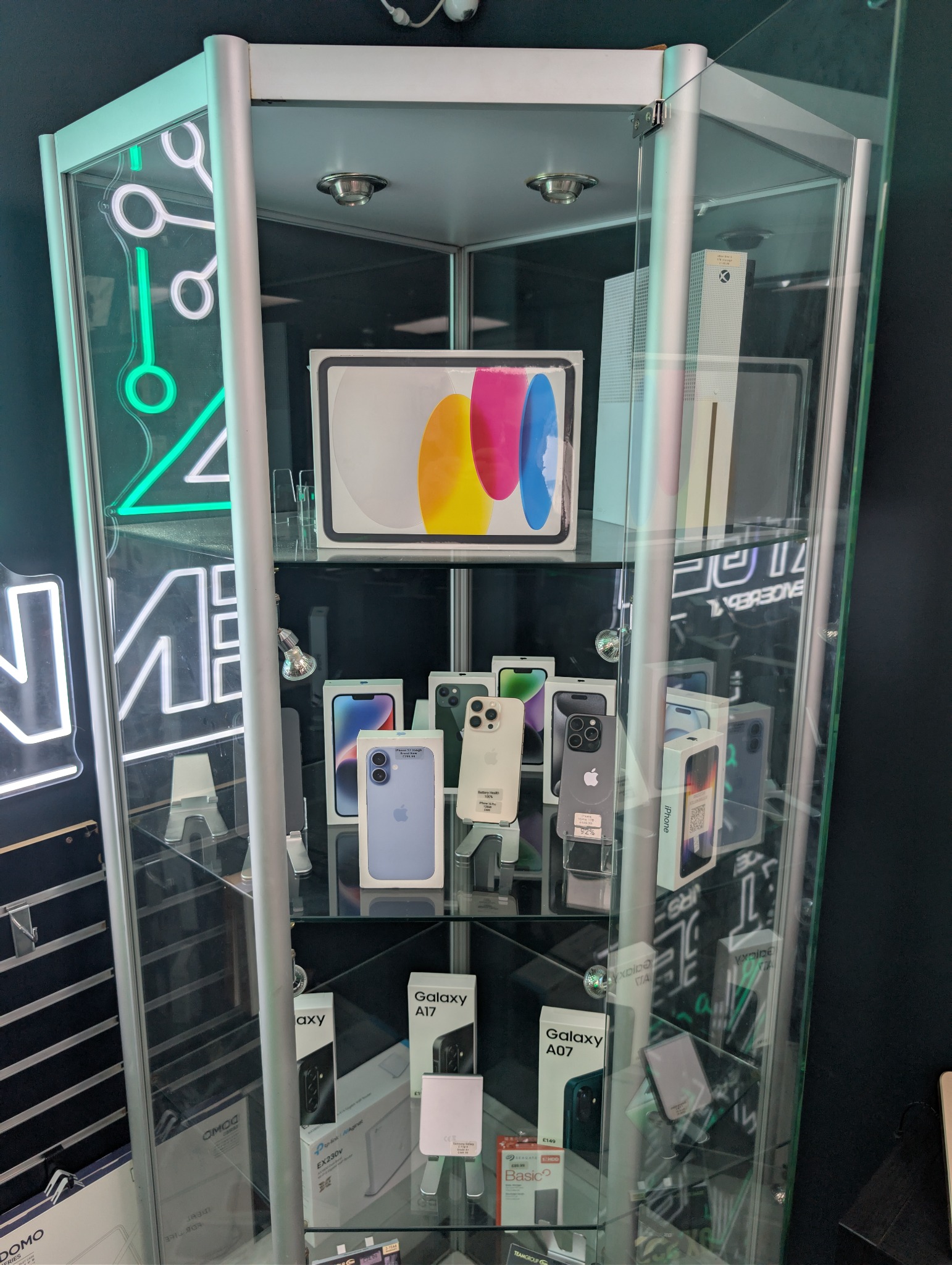 Handsets displayed in the glass cabinet inside NXT GEN Tech Repairs